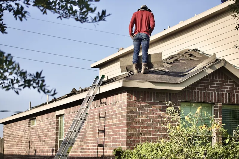 Professional roofer working on a residential roof in Estates of Swan Lake